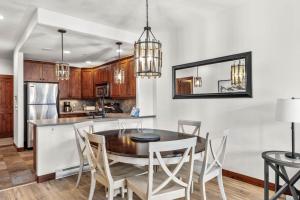 a kitchen and dining room with a table and chairs at Trappers Landing #30 in Sun Peaks