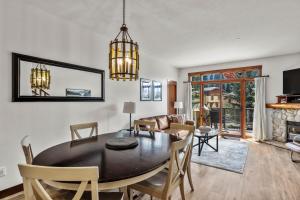 a dining room and living room with a table and chairs at Trappers Landing #30 in Sun Peaks