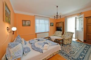 a bedroom with a bed and a living room at Ambrózia Villa in Balatonfüred