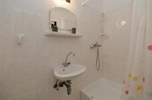 a white bathroom with a sink and a shower at Ambrózia Villa in Balatonfüred +11 photos