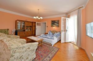 a living room with a couch and a table at Ambrózia Villa in Balatonfüred