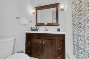 a bathroom with a sink and a mirror at Tropical Oasis with Heated Pool and BBQ in Tamiami +12 photos