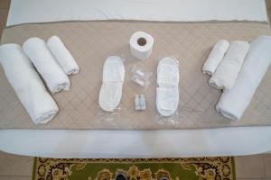 a table with towels and toilet paper on it at WHITEHOUSE in Lecce +63 photos