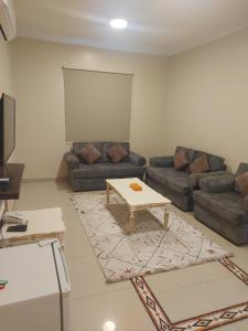 a living room with a couch and a table at دره الرياض للشقق الفندقيه in Riyadh +24 photos