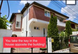 a sign on a fence in front of a house at Central DELUXE Apartment in Prilep