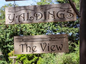 two wooden signs hanging from a pole at The View in Faversham
