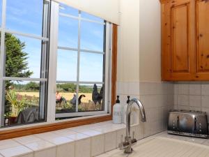 a kitchen with a window with a view of a field at The View in Faversham