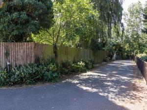 a wooden fence next to a road next to a fence at The View in Faversham