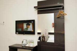 a television hanging on a wall in a room at New Century Hotel Melaka in Malacca