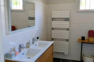 a bathroom with a sink and a mirror at Maison de vacances jusqu'à 6 personnes, classée 3 étoiles in Échillais +27 photos