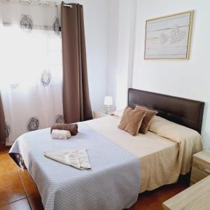 a bedroom with a bed with a towel on it at Apartamento Playa Rosa in Guía de Isora +13 photos