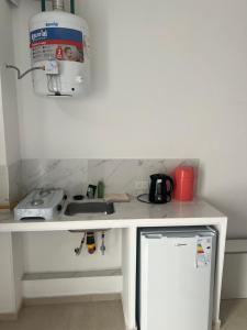 a kitchen counter with a sink and a microwave at studios in Cordoba in Córdoba