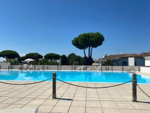 a large swimming pool with a rope around it at Delphina House in Lido delle Nazioni