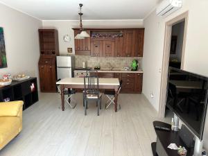a kitchen with a table and chairs in a room at Casa dolce casa in Trecastagni