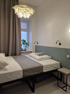 a bedroom with a bed and a window and a chandelier at CAPSULE HOTEL & HOSTEL in Kharkiv +50 photos