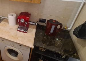 a kitchen with a red blender on a counter at Cozy studio in noble house main square in Cluj-Napoca +2 photos