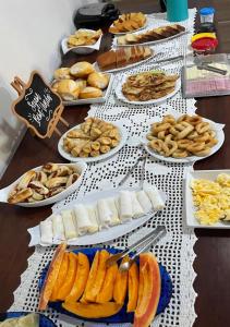 a table with many different types of food on it at Pousada Cunhantã in Alter do Chao