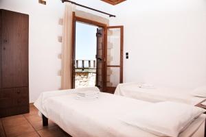 A bed or beds in a room at Tsivaras Villas