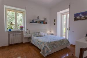 a bedroom with a bed and a sink and windows at Casa Elianta in Vico Equense