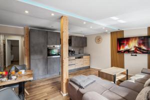 a living room with a couch and a table at Garten - Bergblick - SmartTV - Parkplatz - HarzLounge in Thale +6 photos