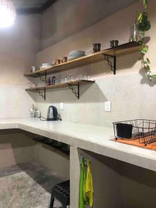a kitchen with shelves and a counter in a room at Villa Siloe in Las Delicias