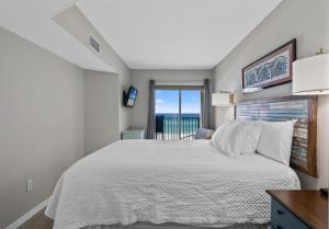 a bedroom with a white bed and a window at Sundunes Unit 133 in Navarre +42 photos