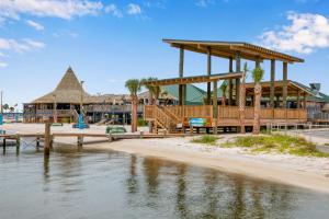a building on the beach next to the water at Sundunes Unit 133 in Navarre