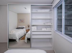 a bedroom with a bed and a glass closet at Cityscape Views - New 2BR Retreat in Asuncion +30 photos