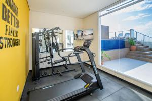 a gym with a treadmill and a large window at Cityscape Views - New 2BR Retreat in Asuncion