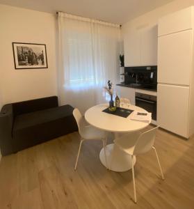 a small living room with a table and a couch at Casettadellafotografia in Senigallia