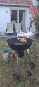 a barbecue grill with pizza on it in a yard at la maison de westende in Middelkerke