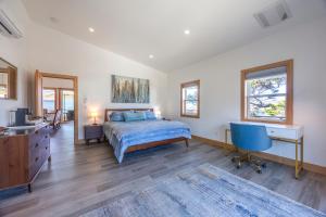 a bedroom with a bed and a desk and a television at 3 bd 3 ba and Bunks - Blue Door Retreat - New in 2024 in Lincoln City