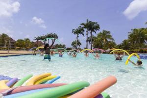a group of people playing in a swimming pool at NEW ! 3 pièces avec piscine et plage accessibles à pieds in Sainte-Luce