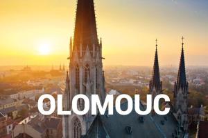 an image of a clock tower with the word orange on it at APARTMÁN pro turisty i home office in Olomouc