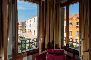 a room with a window with a view of a city at Hotel Tiziano in Venice