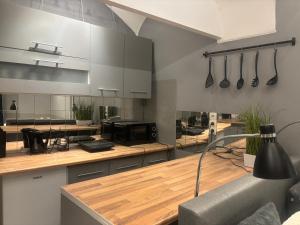 a large kitchen with wooden counter tops and appliances at Studio Old Town in Maribor