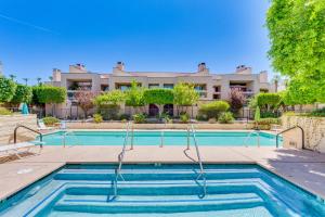 a swimming pool in front of a building at Community Pool Access Chic Palm Springs Condo in Palm Springs