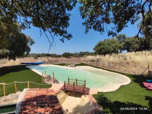 a swimming pool in the middle of a field at Rucanon 2 La casa del campo 4 Estrellas, Piscina y Golf in Montánchez