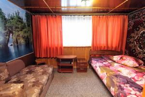 a bedroom with a bed and a table and a window at Апартаменти з гарним краєвидом in Yablunytsya +15 photos