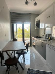 a kitchen with a table and chairs in a room at Sevez Apartments & Homes in Gelibolu