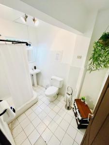 a white bathroom with a toilet and a sink at Casa ELA Candelaria in Antigua Guatemala +70 photos