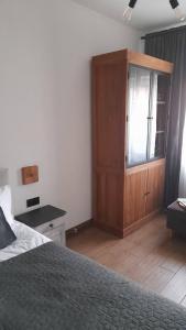 a bedroom with a bed and a wooden cabinet at Hory Opawskie in Głuchołazy