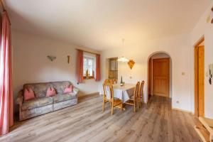 a living room with a couch and a table at Appartement Anger in Lutago