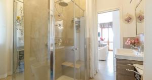a bathroom with a shower and a sink at La perla di Trevignano in Trevignano Romano +30 photos