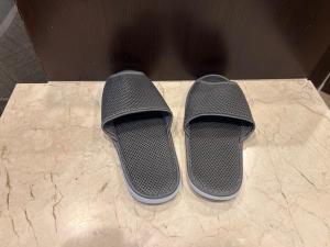 two black shoes sitting on top of a table at Dormy Inn Express Koriyama in Koriyama