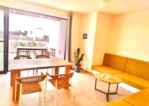 a living room with a couch and a table and chairs at Stylish Lagoon Paradise Apartment Boa Vista in Sal Rei