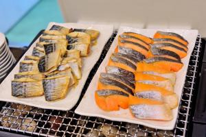 two plates of food sitting on top of a table at Dormy Inn Express Koriyama in Koriyama