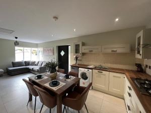 a kitchen and living room with a table and chairs at Dinnys Cottage, Free Parking, Bike Hire in Killybegs