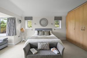 a bedroom with a large bed and a couch at The Bay Tree Bed & Breakfast in Alton