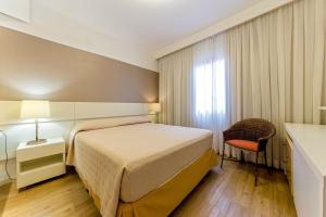 Resort pé na areia - Suítes JBVTOP客房内的一张或多张床位